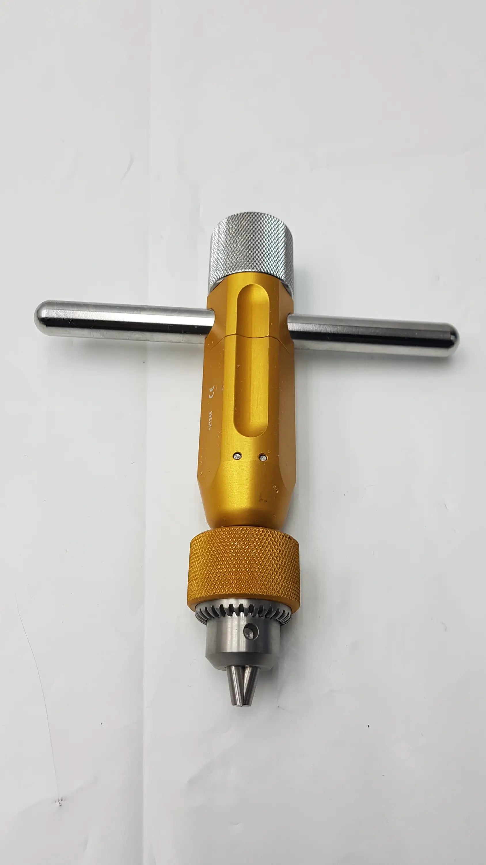Gold-colored arthrex ar-1415t tube harvester driver extractor with textured oats chuck handle and silver metallic accents