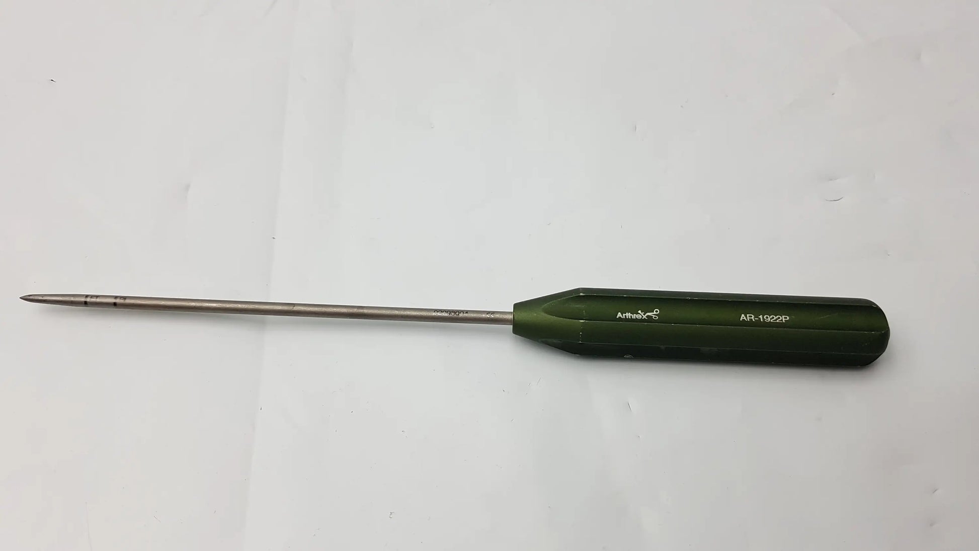 Green-handled ar-1922p surgical instrument with long slender metal shaft and pointed tip for corkscrew ft systems use