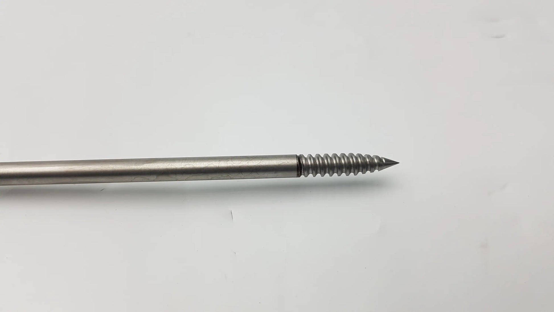 Silver-colored metal punch tap with threaded shaft and pointed tip for 4.75mm swivelock anchor systems by arthrex