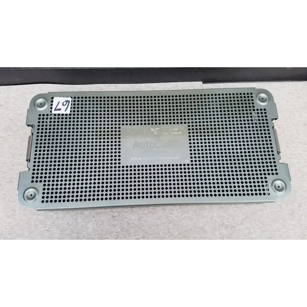 Gray perforated metal sterilization tray from the autocuff opus collection labeled autocult for arthrocare use