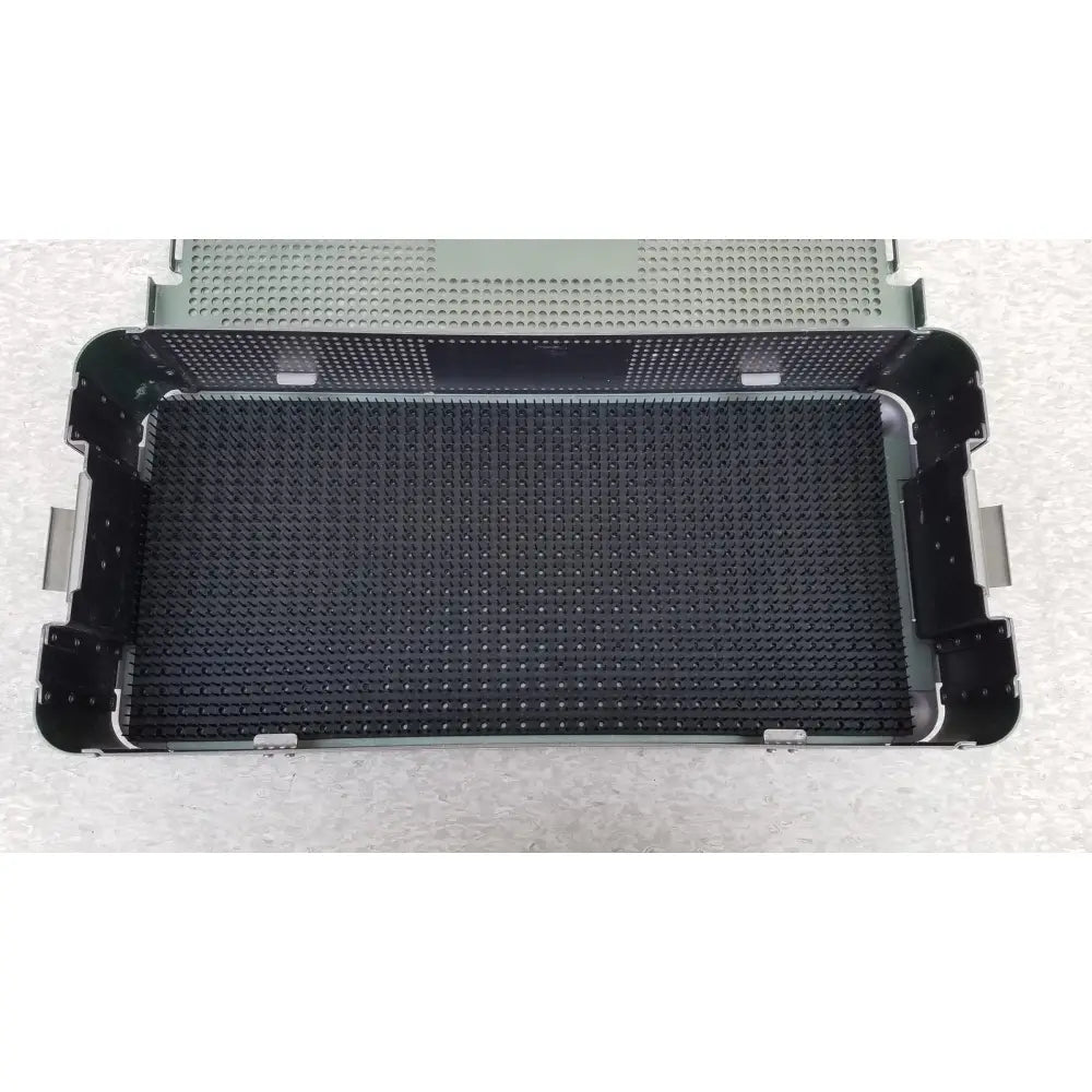 Black perforated metal surgical sterilization tray with reinforced corners and textured grid in autocuff opus collection
