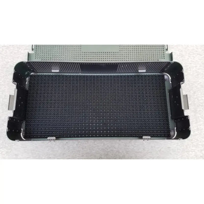 Black perforated metal surgical sterilization tray with reinforced corners and textured grid in autocuff opus collection