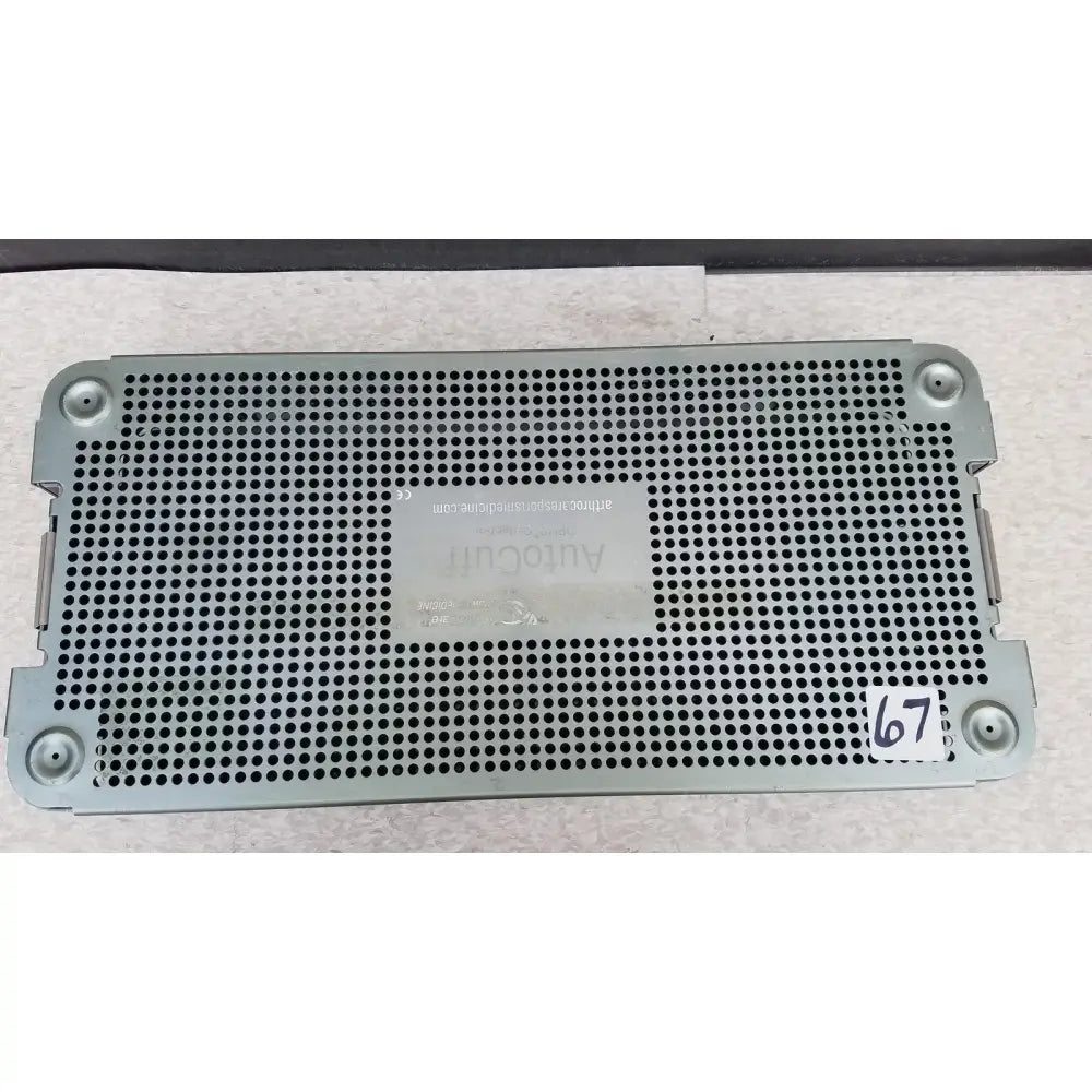 Silver perforated metal panel labeled autocut 67 on the arthrocare autocuff opus collection sterilization tray