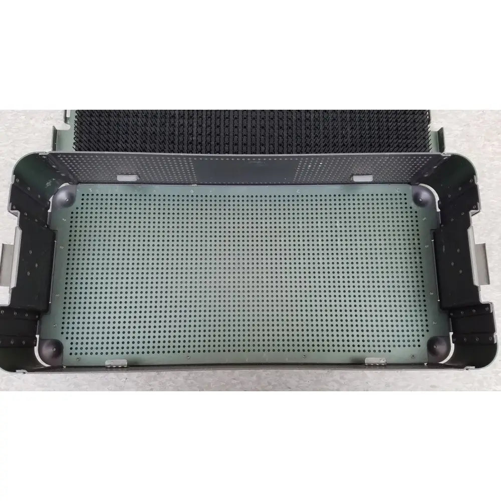 Green perforated metal sterilization tray with black reinforced corners and handles from ArthroCare AutoCuff OPUS collection