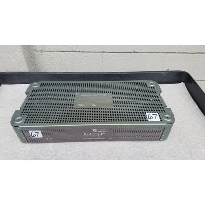 Gray perforated metal medical sterilization tray from arthrocare autocuff opus collection with brand label and website sticker