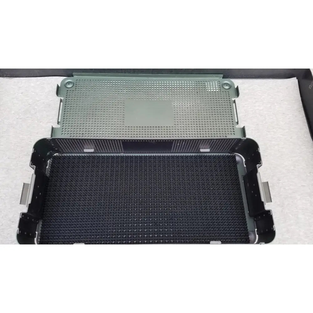 Black and olive green perforated plastic sterilization trays with reinforced metal edges from autocuff opus collection