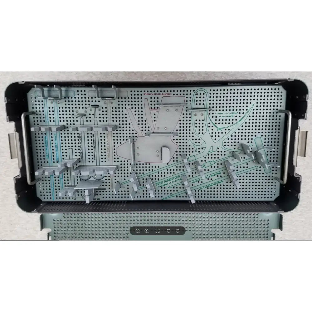Silver metal sterilization tray with perforated surface and compartments holding orthopedic tools from autocuff opus collection