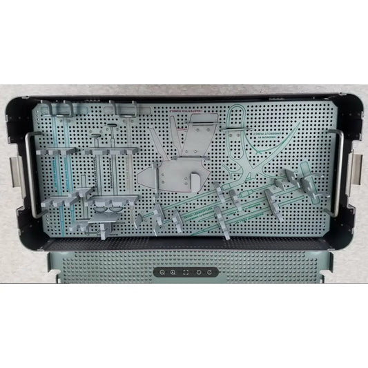 Silver metal sterilization tray with perforated surface and compartments holding orthopedic tools from autocuff opus collection
