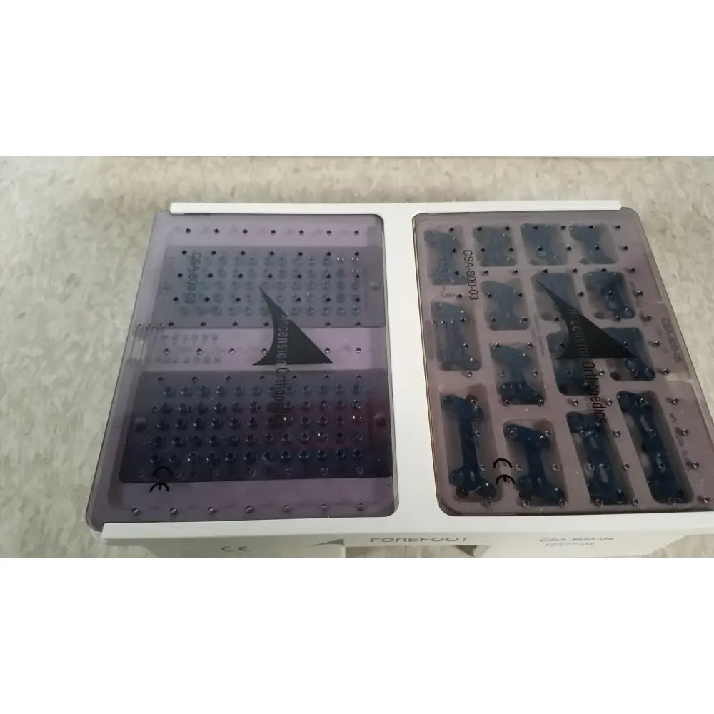 White plastic dental implant tray with transparent purple inserts containing titanium implants for ascension forefoot set ref csa-800-01