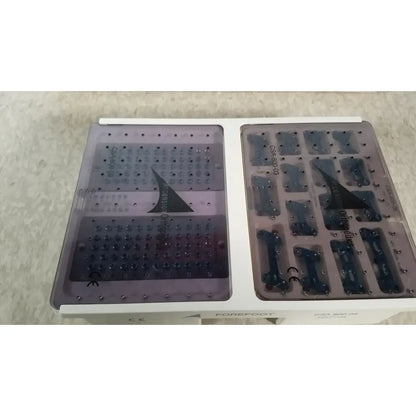 White plastic dental implant tray with transparent purple inserts containing titanium implants for ascension forefoot set ref csa-800-01