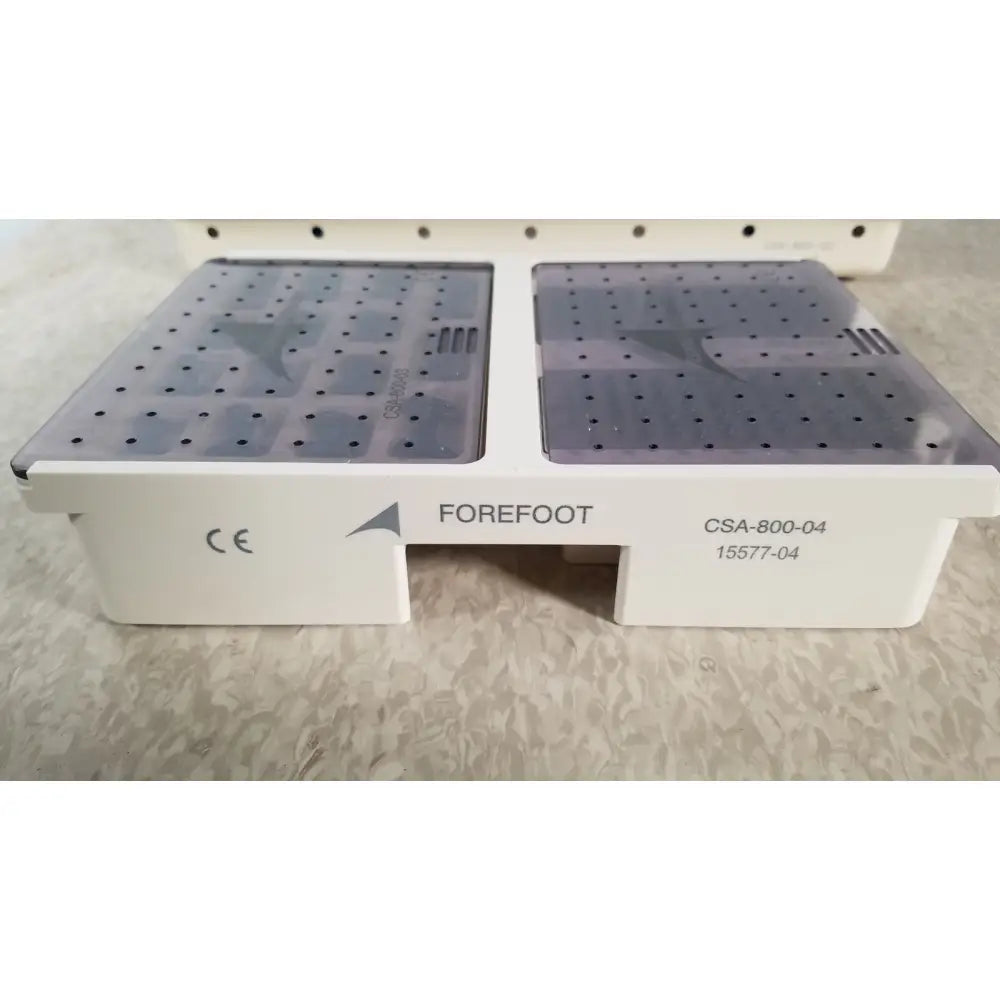 White plastic orthopedic foot support device with gray perforated panels labeled forefoot from ascension forefoot set ref csa-800-01