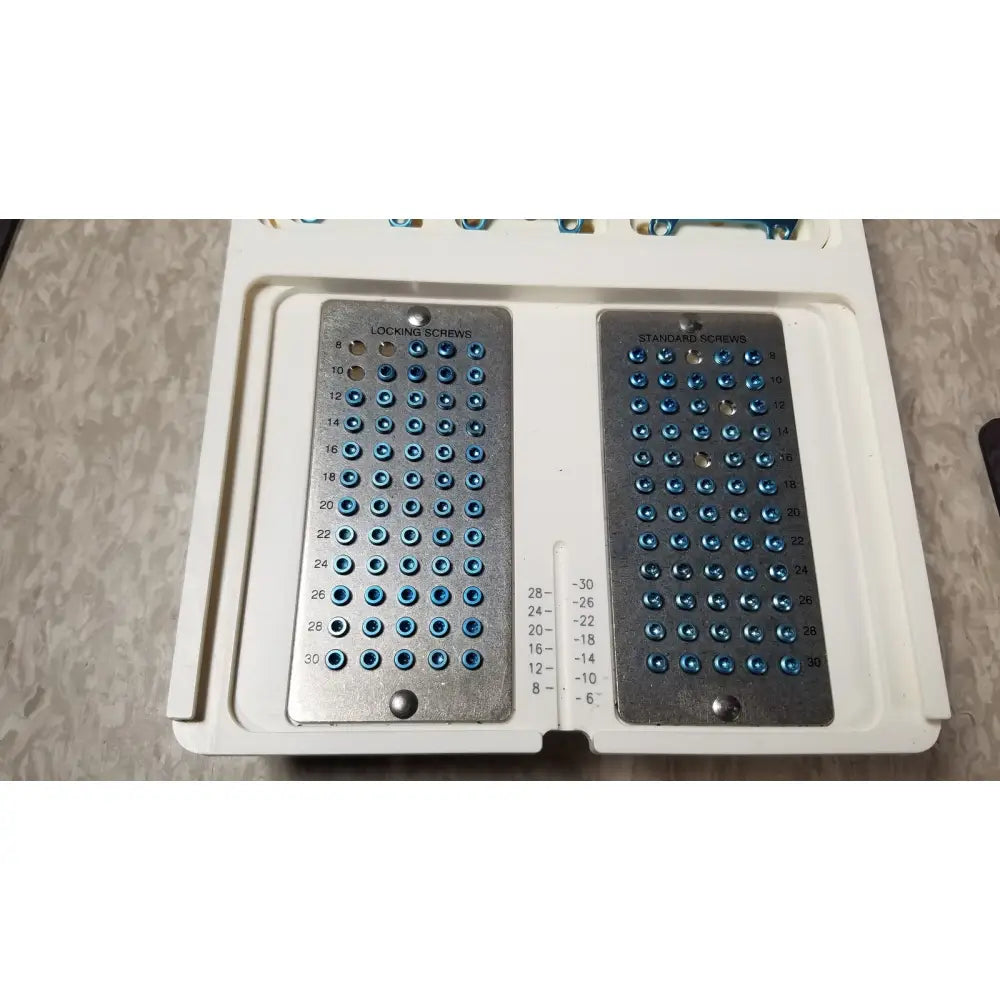 White plastic case with metal trays containing blue head locking screws and standard screws for ascension forefoot set ref csa-800-01