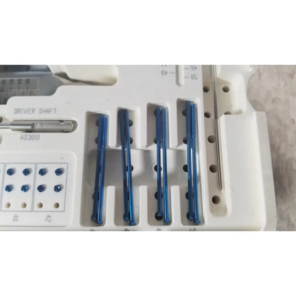 Blue ascension ref csa-5001-001 capture screws arranged in a white plastic tray for surgical instrumentation use