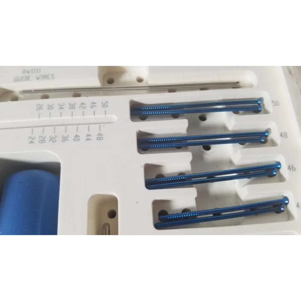 Blue metallic surgical guide wires organized in a white tray for ascension ref csa-5001-001 capture screws instruments