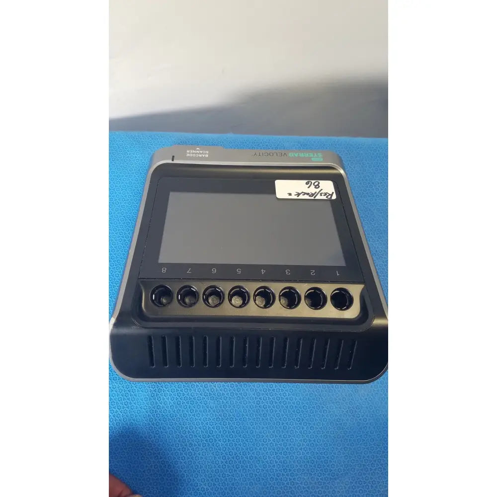 Black and silver asp sterrad velocity barcode scanner reader with touchscreen and eight circular ports below screen