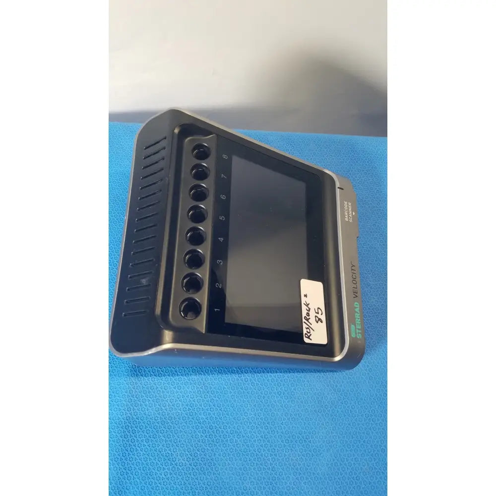 Black and gray asp sterrad velocity 85 diagnostic device with screen, numbered ports, and ventilation slits for sterrad velocity barcode scanning