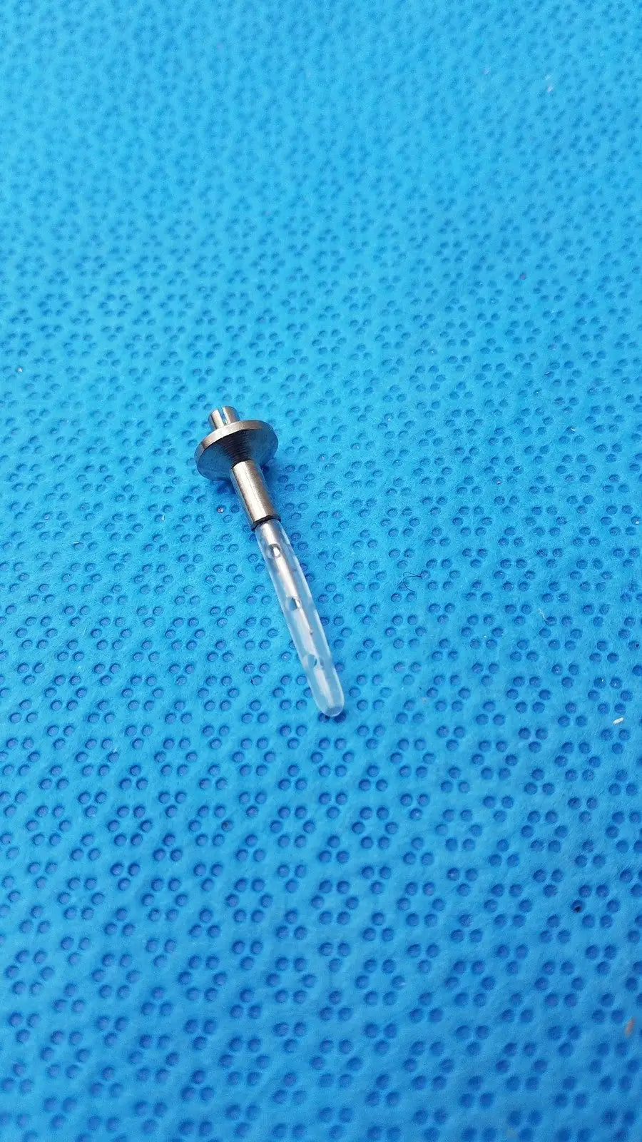 A transparent dental implant screw with metallic threaded head and shaft for assembly burr corenal rust ring removal