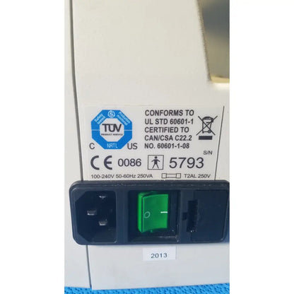 Black power input panel with green toggle switch and certification labels on back of audioscan verifit vf-1 hearing analyzer