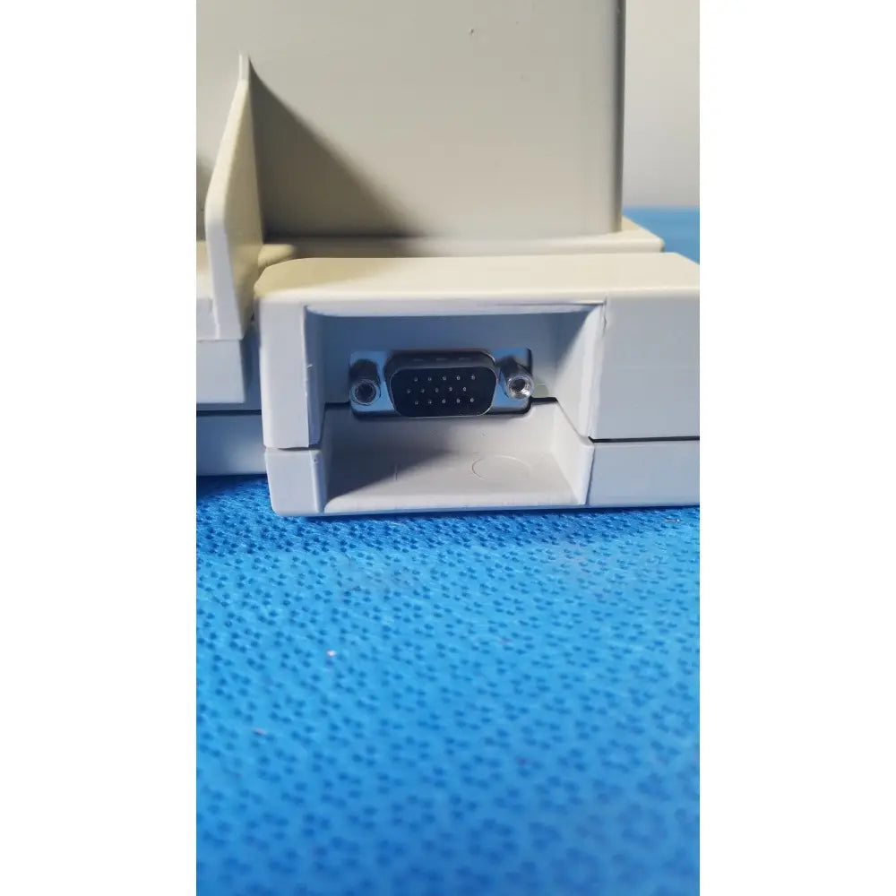 Beige plastic audioscan verifit vf-1 hearing analyzer back side showing black vga port and silver screws