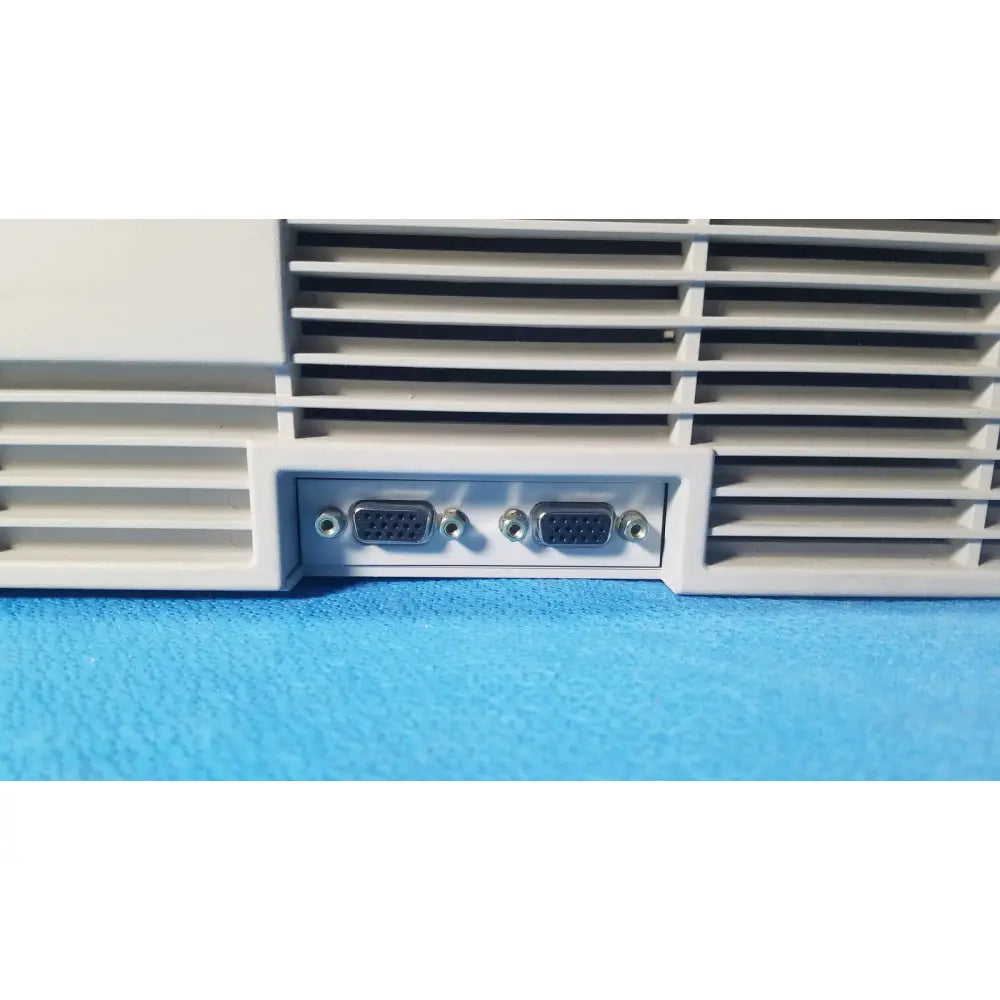 Back side of white audioscan verifit vf-1 hearing analyzer with two black vga ports and silver screws in vent panel