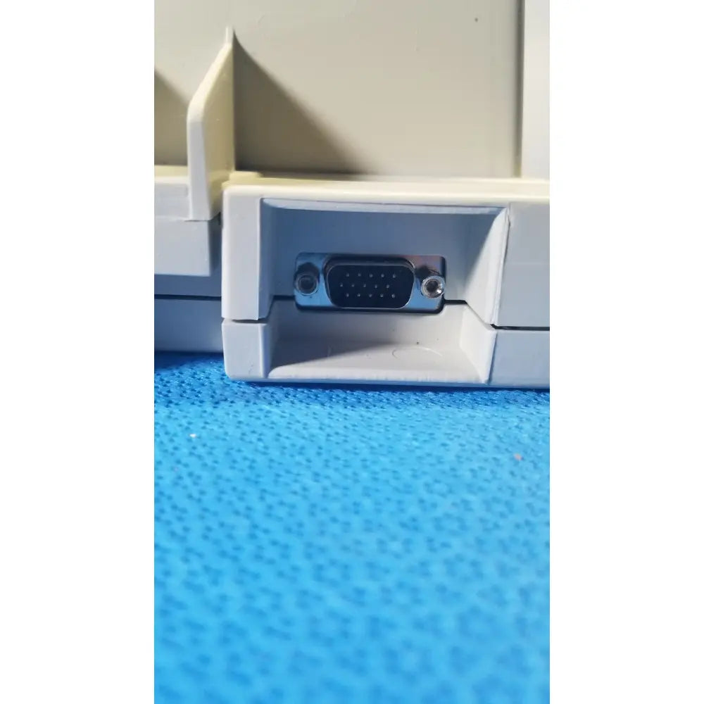 Beige plastic back housing of audioscan verifit vf-1 hearing analyzer with silver vga port and screws on either side