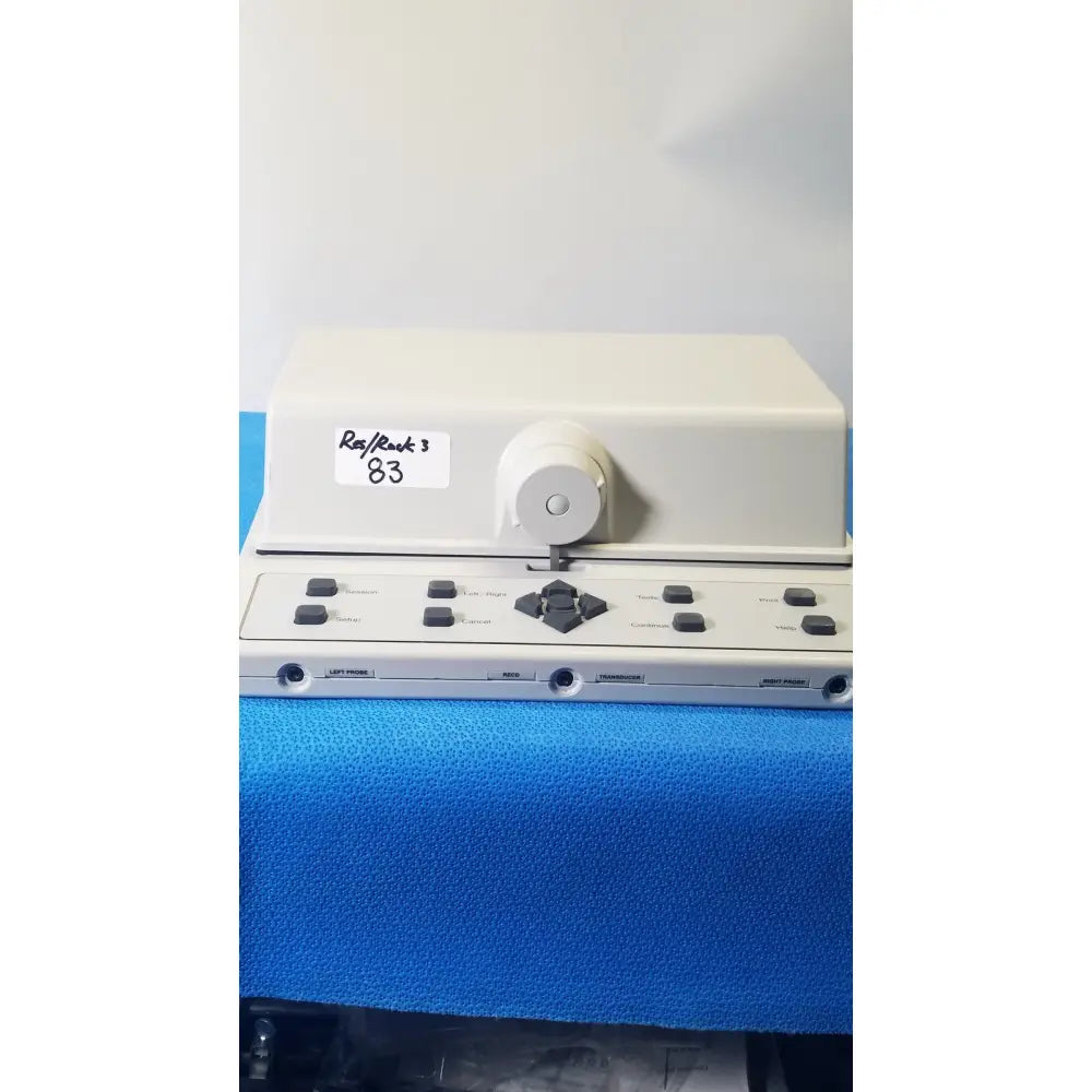 Cream-colored rast ruck 3 dental handpiece with black buttons and dial shown with audioscan verifit vf-1 hearing analyzer