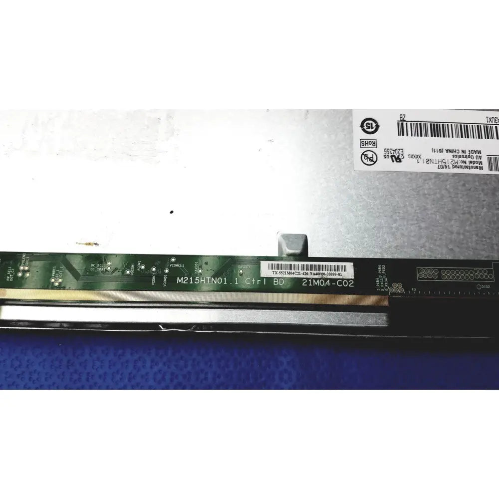 Green circuit board with gold contacts and barcode on the back of auo m215htn01 lcd screen panel