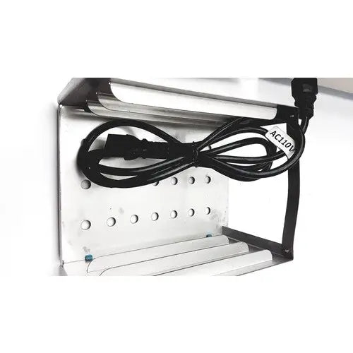 Silver metal shelf of autoclave portable steal sterelizer packing tr250nm-1 with black power cord coiled on top