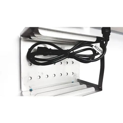 Silver metal shelf of autoclave portable steal sterelizer packing tr250nm-1 with black power cord coiled on top