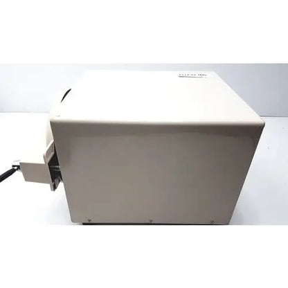 Beige rectangular autoclave portable steal sterelizer packing tr250nm-1 with black cable extending from its side