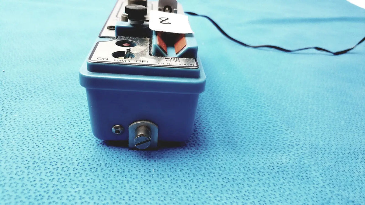 Blue plastic automatic dispensing module control panel with metallic knobs and switches labeled model as-2c