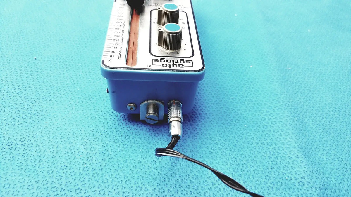 Blue automatic dispensing module electronic device with silver knobs and black cable for precise automatic dispensing