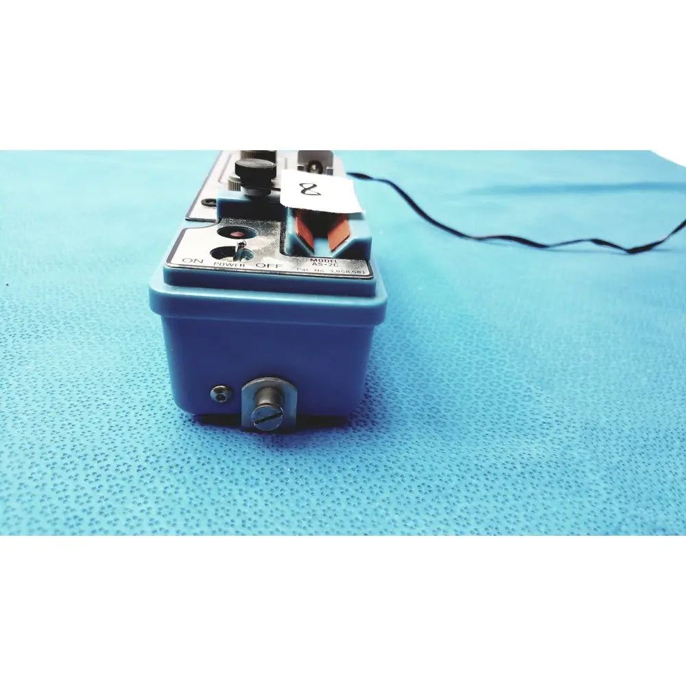 Blue plastic automatic dispensing module control panel with metallic knobs and switches labeled model as-2c