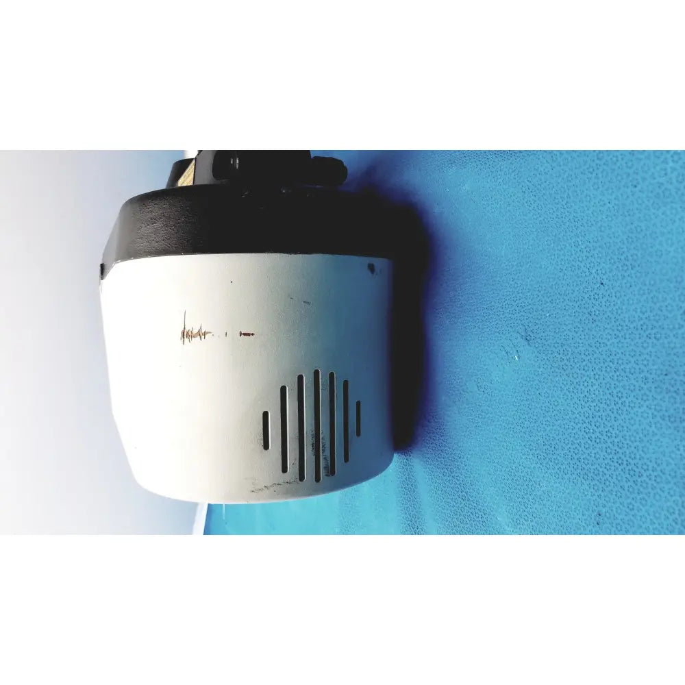 White and black cylindrical security camera with ventilation slits on variable speed grinder-polisher 120v back side
