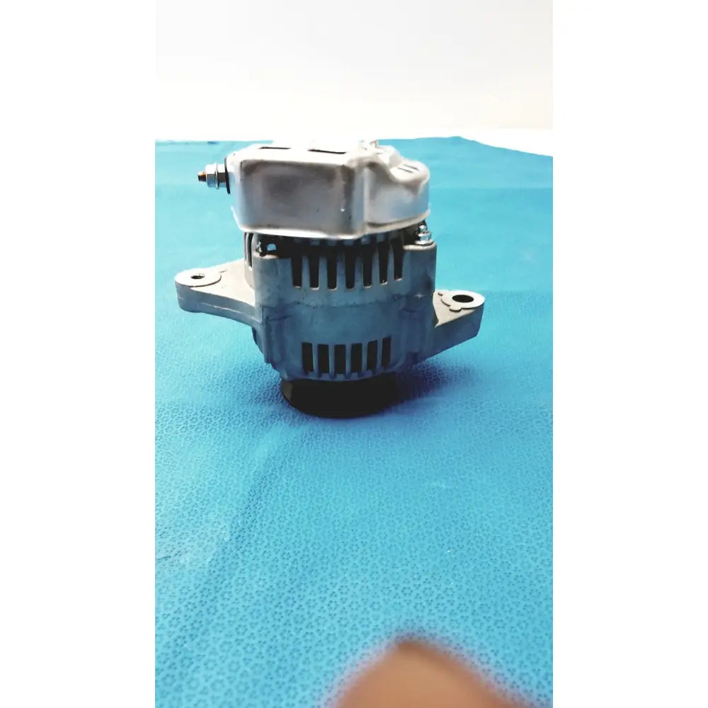 Silver-colored automotive alternator with ribbed housing and mounting brackets for automotive alternator spare use