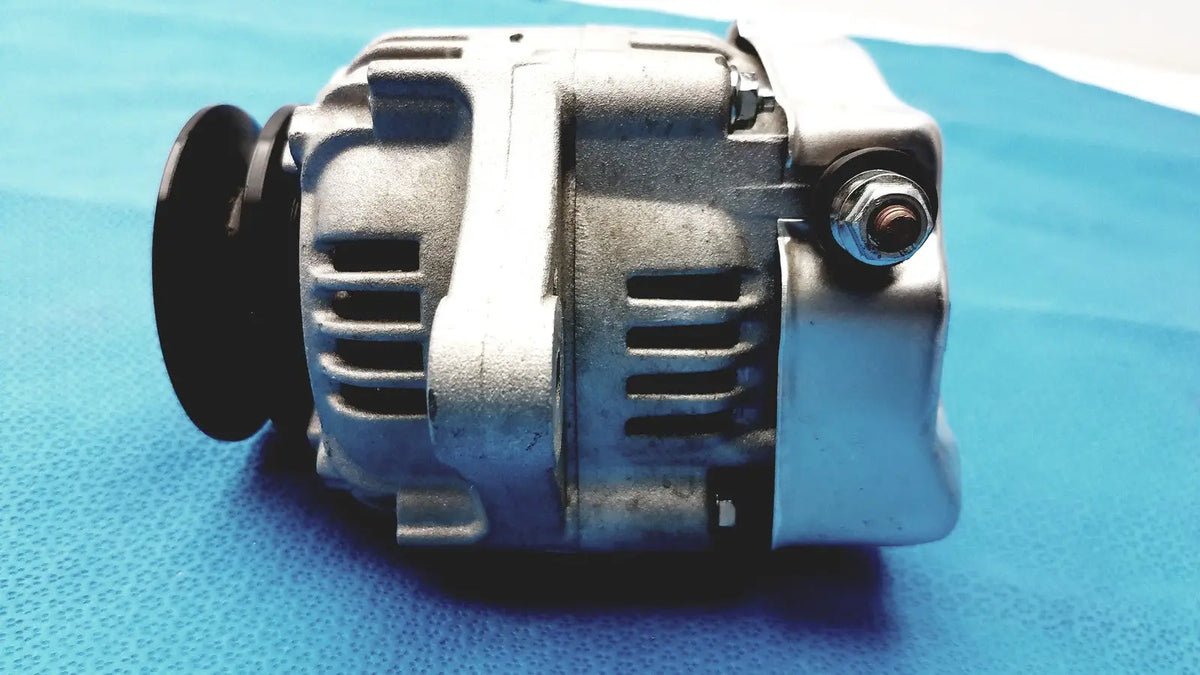 Silver metallic automotive alternator for spare with black pulley and bolted terminals for reliable reuse medical applications