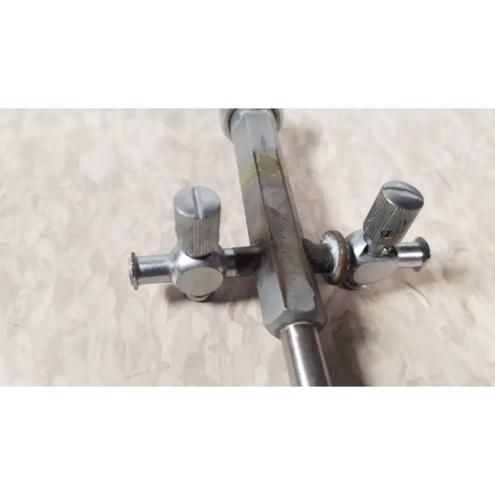 Silver metallic drum key with textured knobs and hexagonal shaft for bainha externa richard wolf 8853.05
