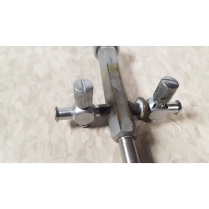 Silver metallic drum key with textured knobs and hexagonal shaft for bainha externa richard wolf 8853.05