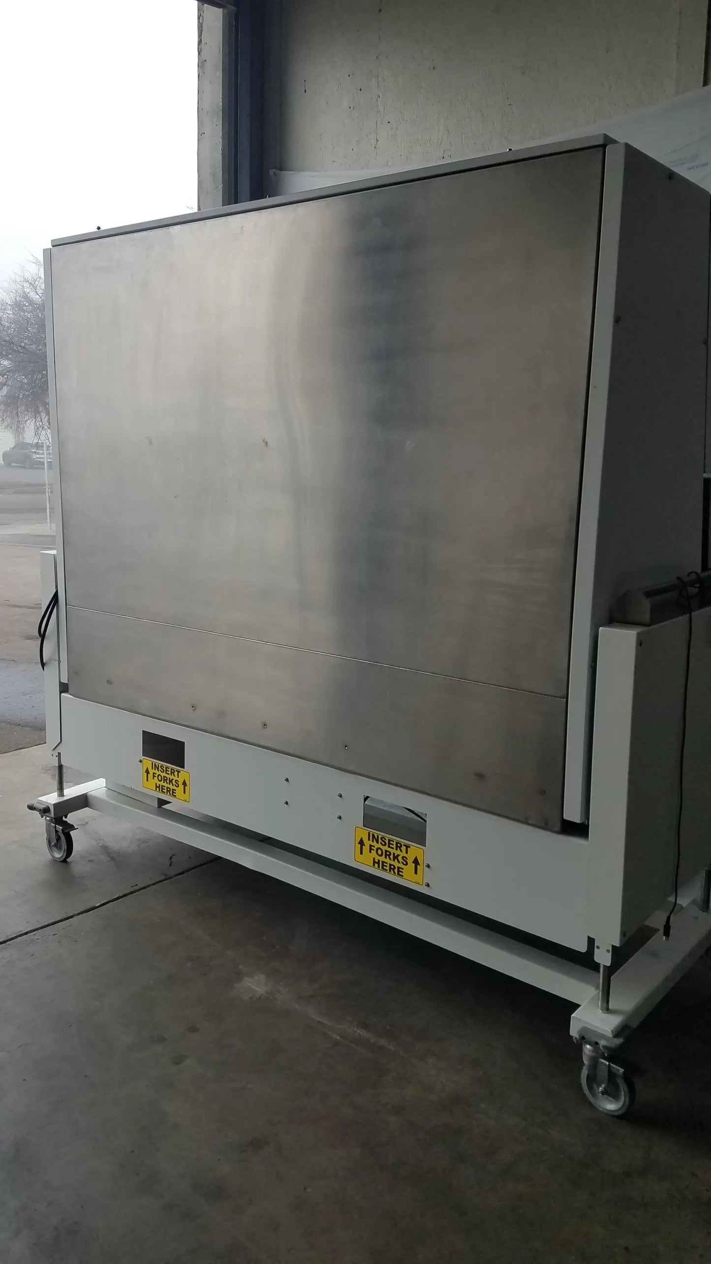 Industrial-grade stainless steel conveyor belt loading station with positive pressure isolator and caster wheels for mobility