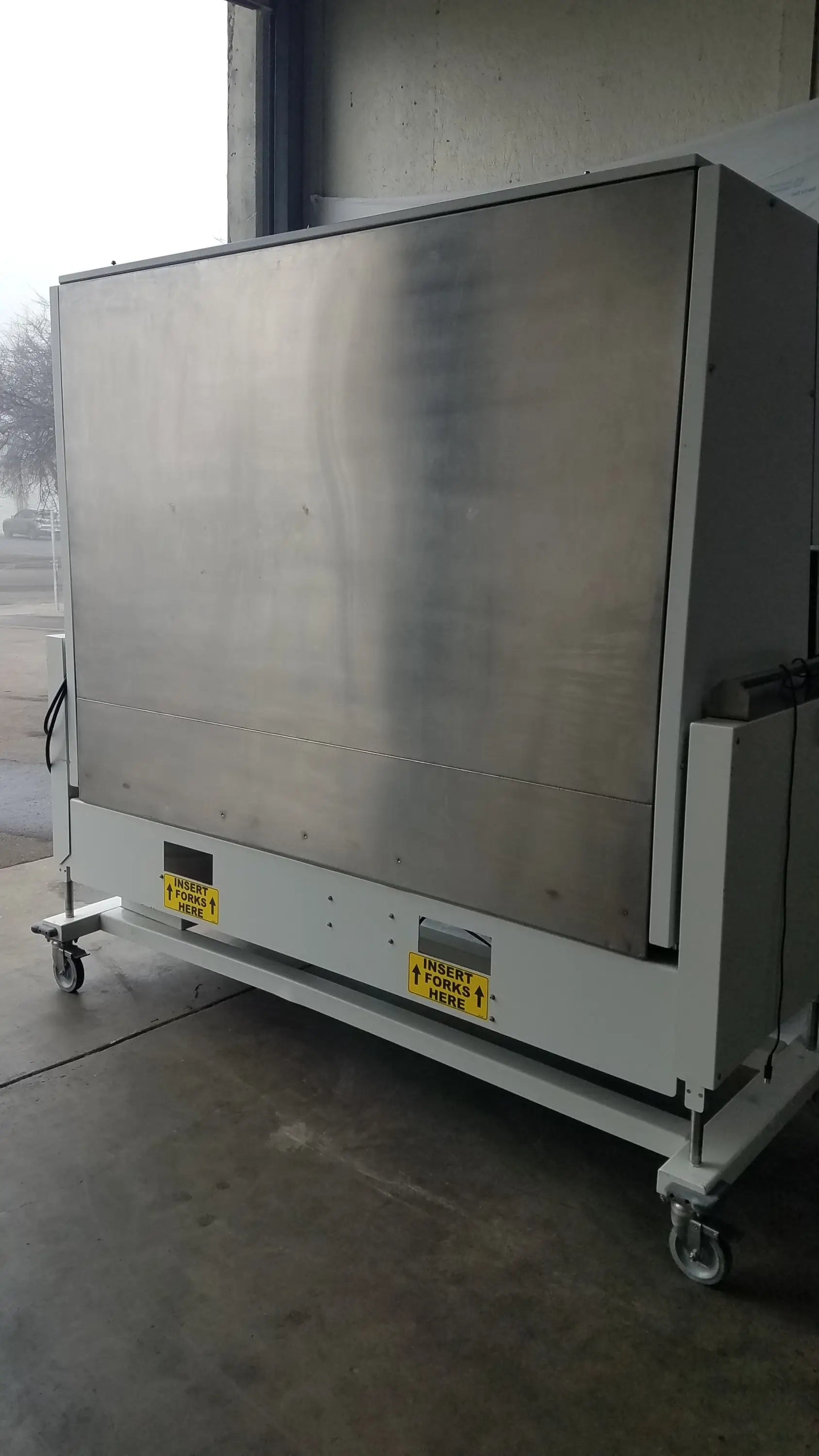Industrial-grade stainless steel conveyor belt loading station with positive pressure isolator and caster wheels for mobility