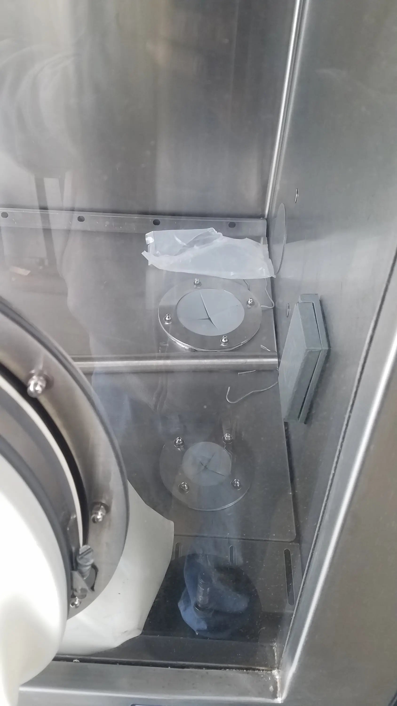 Stainless steel circular access panels with bolted edges and central cutout on baker ss-600 sterilshield positive pressure isolator