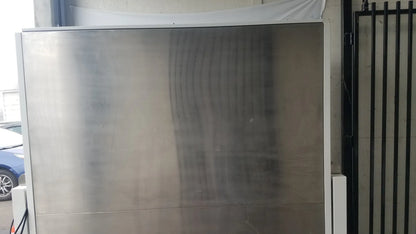 A sleek stainless steel baker ss-600 sterilshield positive pressure isolator door with smooth reflective surface and vertical seams