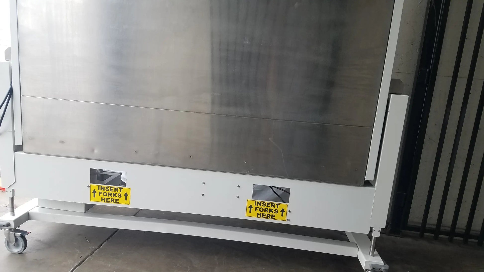 Industrial stainless steel forklift truck with white base and yellow labels for baker ss-600 sterilshield positive pressure isolator