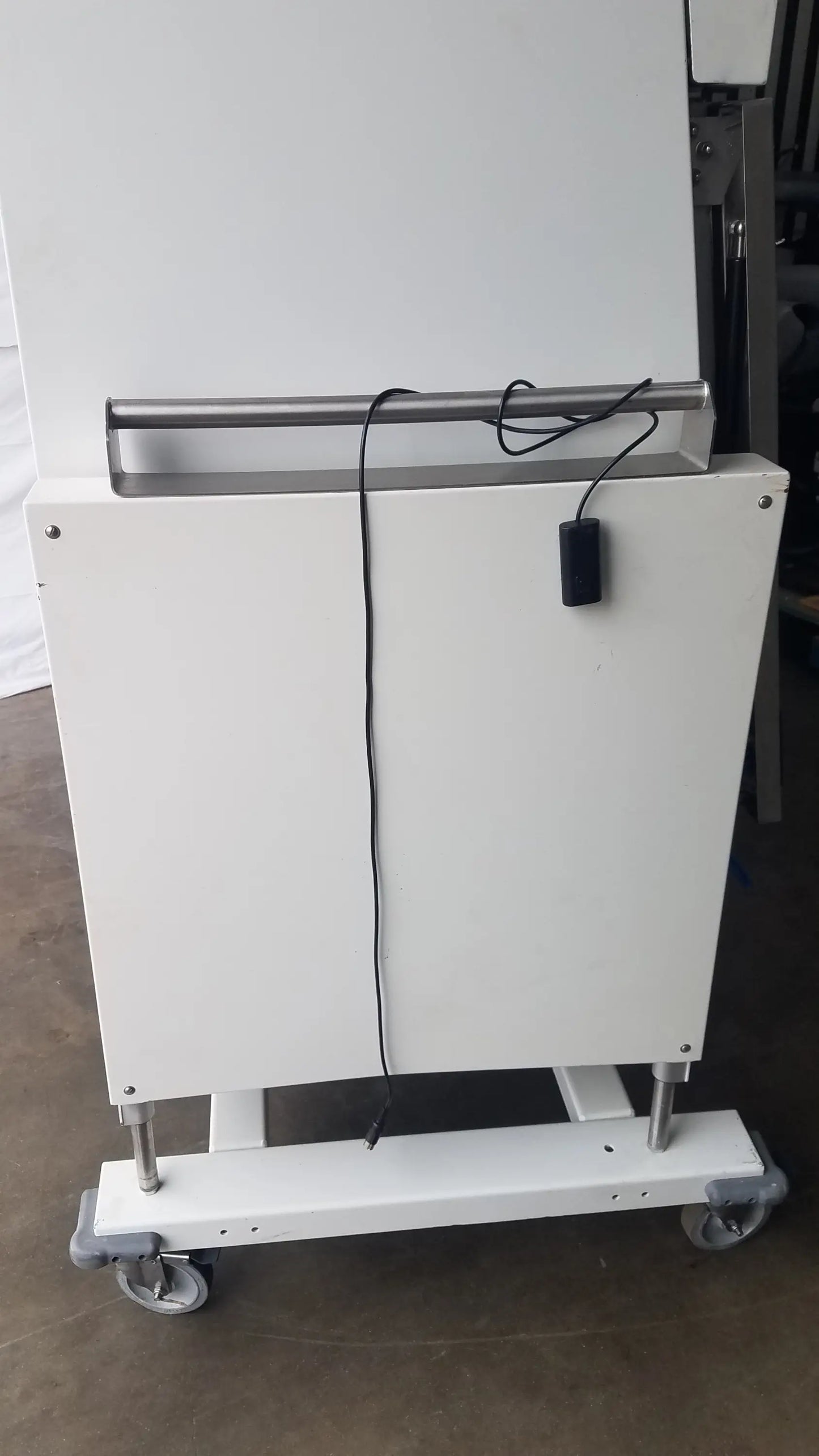 White industrial-grade cart with metal handle and caster wheels for baker ss-600 sterilshield positive pressure isolator