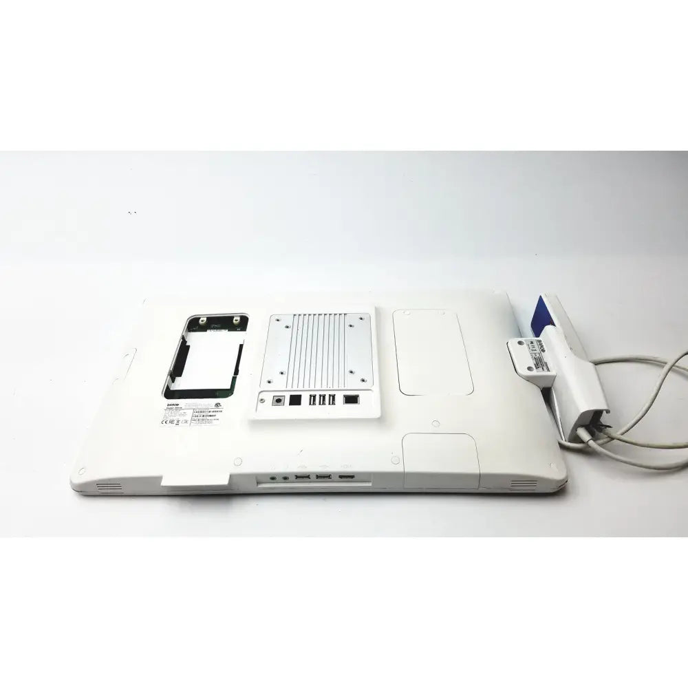 Back view of a white barco ja018 smart terminal with silver metal cooling fan and usb ports for bedside multi-touch use