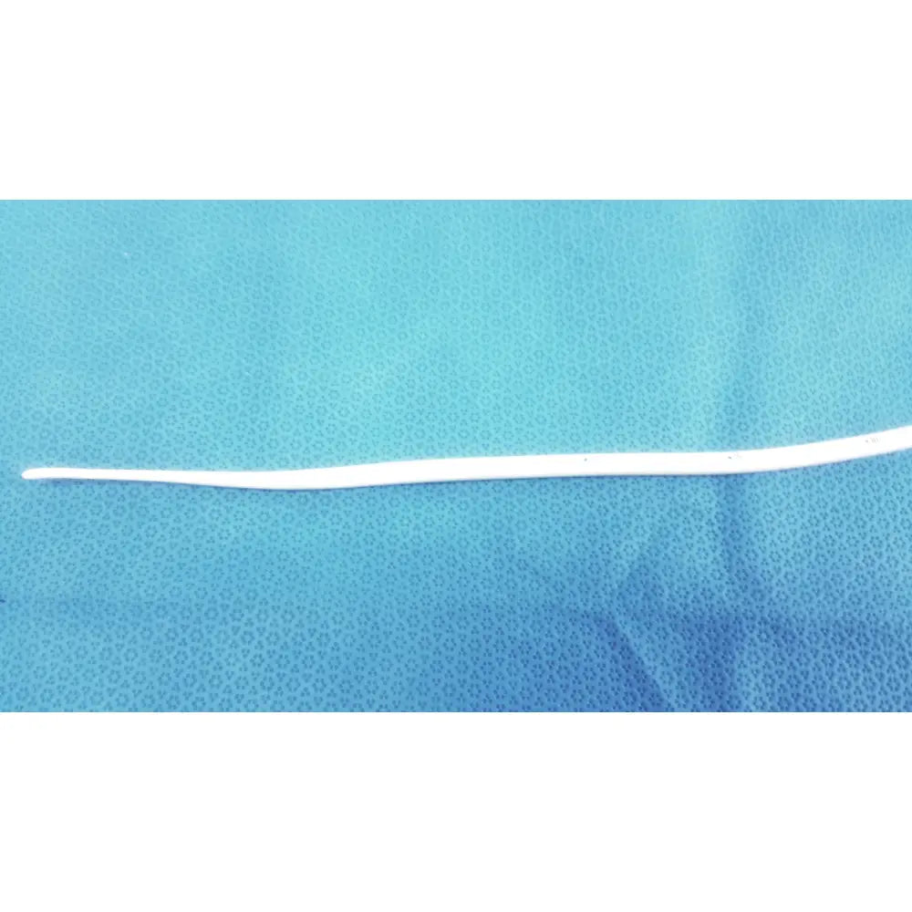 A slender white bard 21fr maloney tapered tungsten-filled esophageal bougie catheter tube on a blue surface