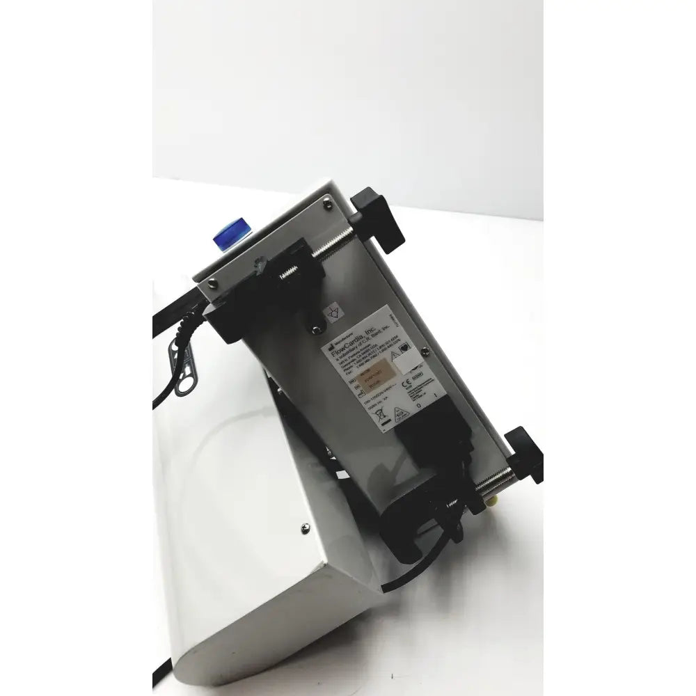 Silver metallic bard peripheral flowmate industrial injector with black components, blue button, wiring, and labeling visible