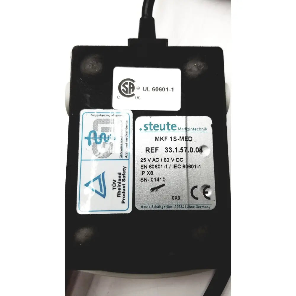 Black rectangular bard peripheral flowmate injector crosser with white certification labels and black power cord visible on back side