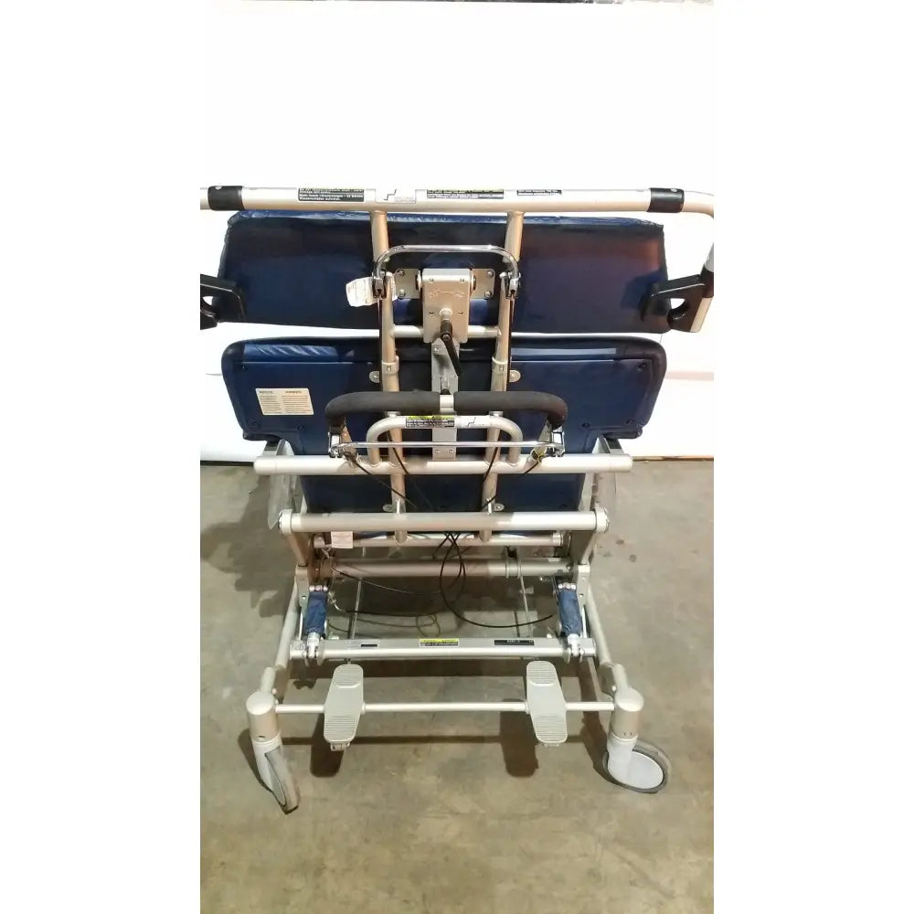 Blue cushioned barton convertible medical chair with silver metal frame and adjustable footrests for patient lifting