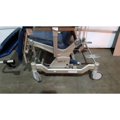 Silver metal-framed barton convertible medical chair with blue padded upholstery and four caster wheels on base
